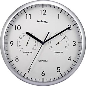 Anogna stenska ura, okrogla ohišje v srebrni barvi, kazalci in številke v črni barvi, bela številčnica. Prikazuje tudi tempereturo in relativno vlago v prostoru